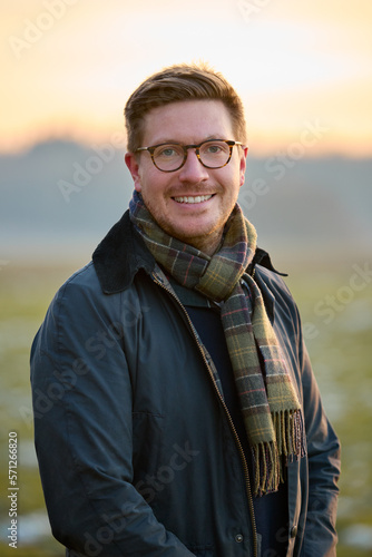 Portrait Of Smiling Man On Snowy Walk In Winter Countryside