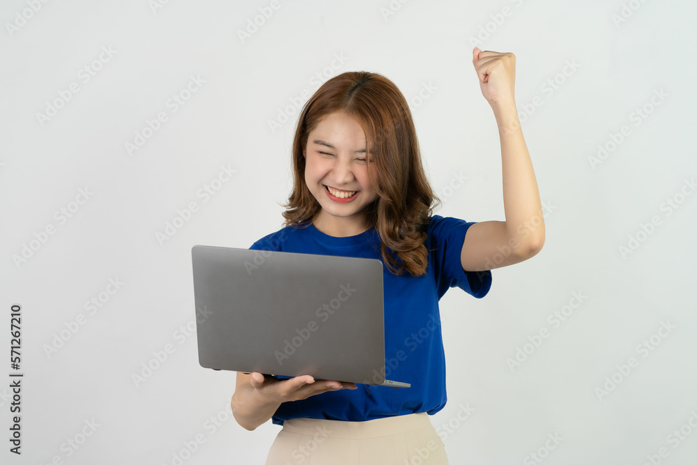 Cute Asian teenage woman smiling happily excited excitedly working with computer on white background Cute Asian teenage woman smiling happily excited excitedly working with computer on white background