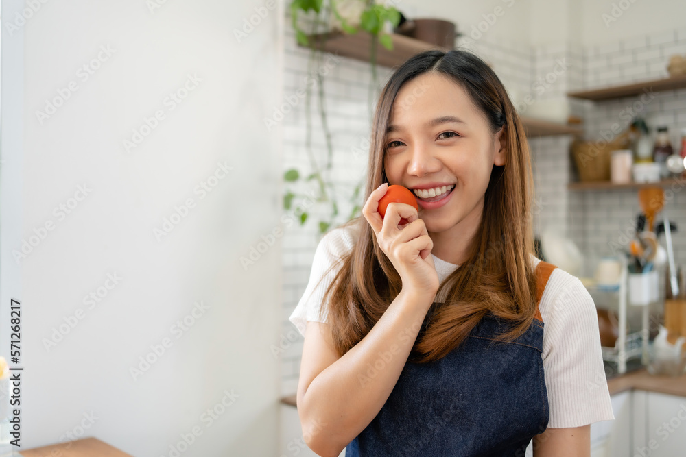Pretty Asian woman preparing healthy breakfast at home in modern and beautiful kitchen, smiling brightly. Pretty Asian woman preparing healthy breakfast at home in modern and beautiful kitchen, smiling brightly.