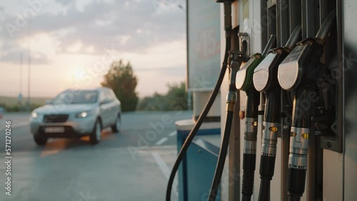 Car drives into gas station to refuel with diesel for travel in summer at dawn. Travel. Tourism
