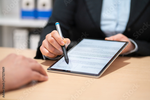 Photography Close up of an executive hands holding a pen with digital tablet and indicating