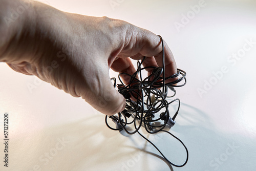 Bilde på lerret Tangled headphone wires in hands