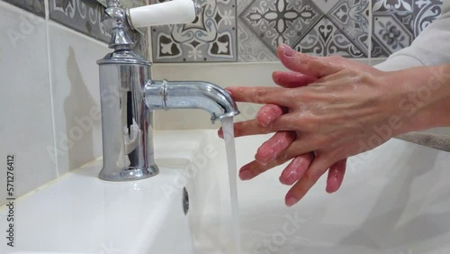 Process of cleaning of hands with water and soap in the bathroom, hygiene concept