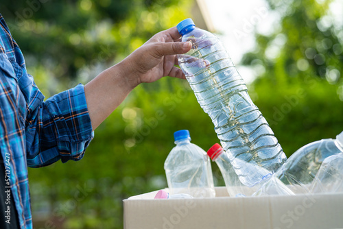 Wallpaper Mural Woman holding plastic bottles garbage in box to reuse recycle for good environment. Torontodigital.ca