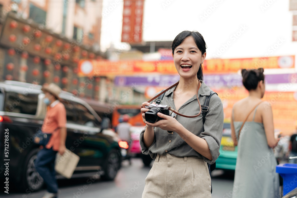 Young Asian woman backpack traveler enjoying China town street food market in Bangkok, Thailand. Traveler checking out side streets. Young Asian woman backpack traveler enjoying China town street food market in Bangkok, Thailand. Traveler checking out side streets.