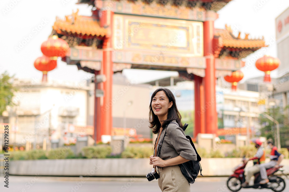 Young Asian woman backpack traveler enjoying China town street food market in Bangkok, Thailand. Young Asian woman backpack traveler enjoying China town street food market in Bangkok, Thailand.