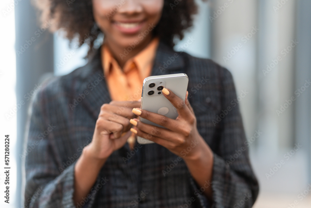 Using mobile and texting, Young pretty african american business woman bookkeepers working with balance sheet yearly reports to calculate tax and online consult in modern office. Using mobile and texting, Young pretty african american business woman bookkeepers working with balance sheet yearly reports to calculate tax and online consult in modern office.