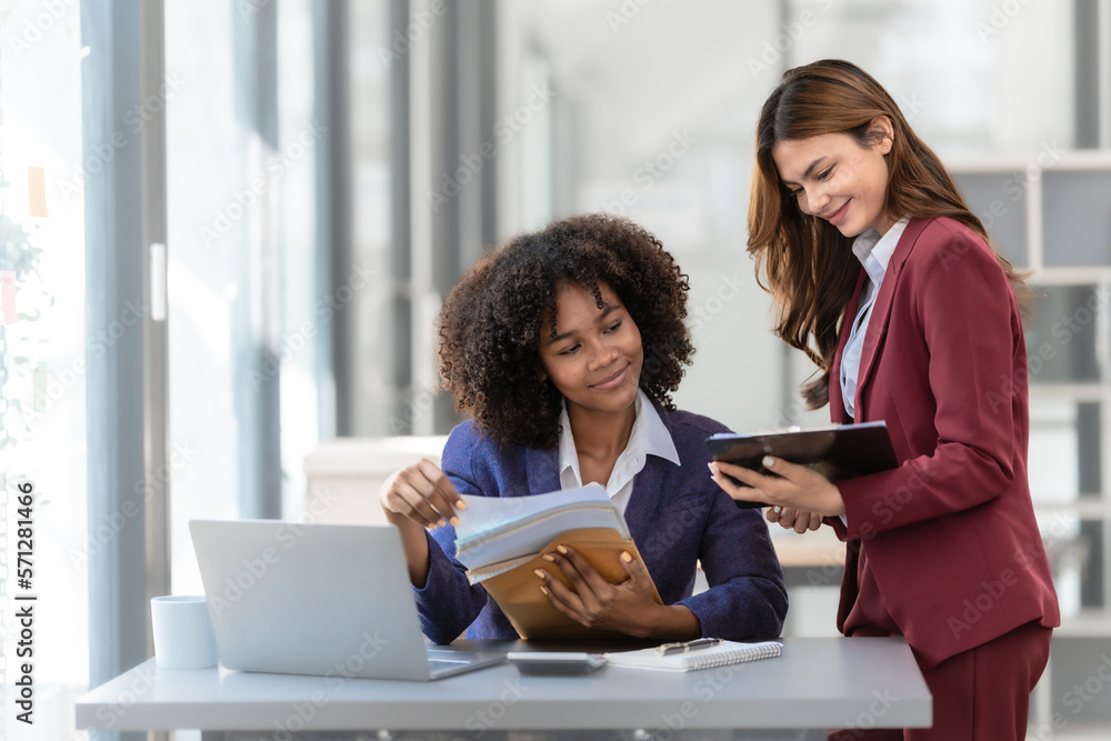 Young trader mixed race woman in formal suit friends consulting and discussing with stock market and cryptocurrency in online trading application. Young trader mixed race woman in formal suit friends consulting and discussing with stock market and cryptocurrency in online trading application.