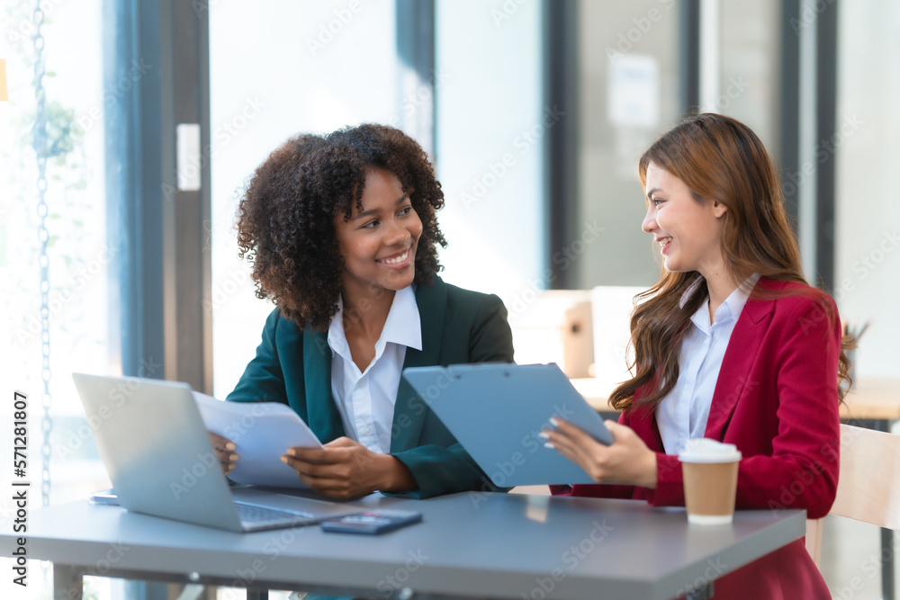 Young trader mixed race woman in formal suit friends consulting and discussing with stock market and cryptocurrency in online trading application. Young trader mixed race woman in formal suit friends consulting and discussing with stock market and cryptocurrency in online trading application.