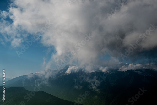 Beautiful mountain landscape, clouds over the peaks of the mountains, sunny day