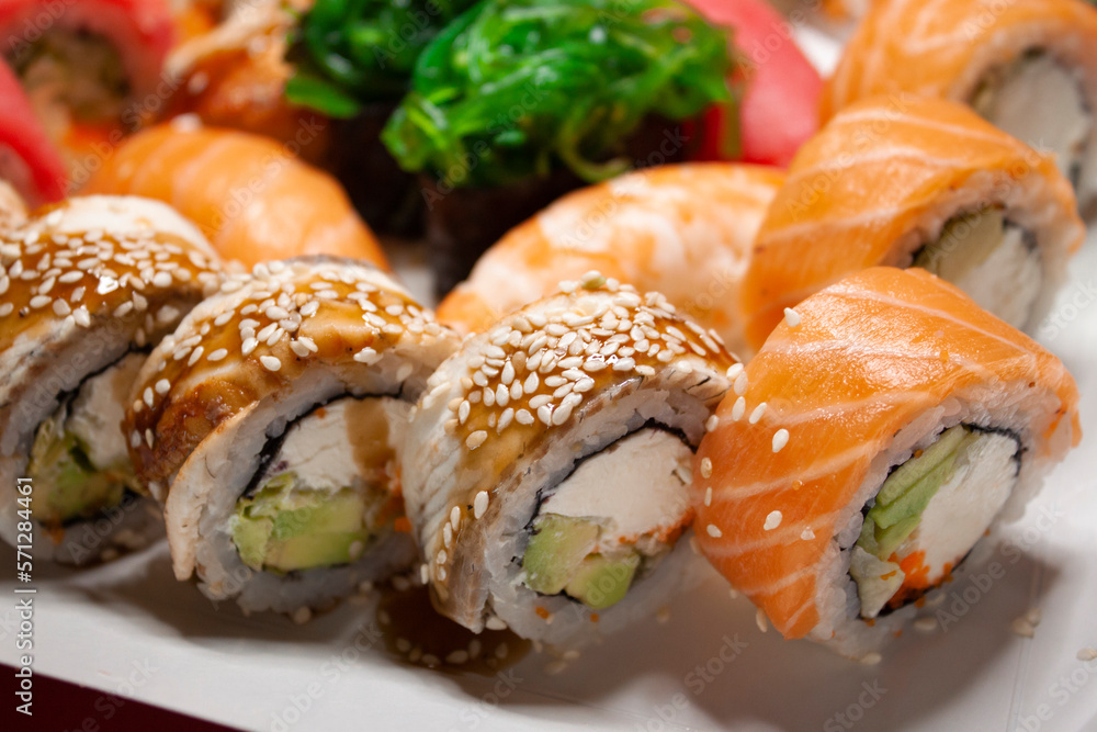 salmon tuna chuka shrimp eel nigiri gunkan sushi rolls set in white box on red background salmon tuna chuka shrimp eel nigiri gunkan sushi rolls set in white box on red background