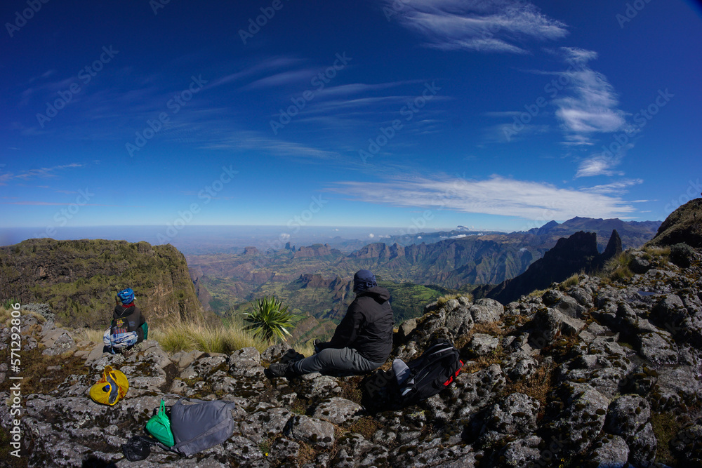 Panoramic view of mountains with hiker and scout in foreground in the Simien Mountains Ethiopia, Africa