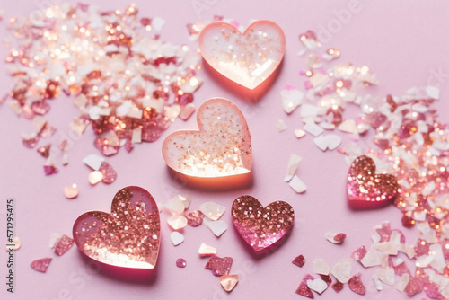 Valentine's Day background. Shades of pink resin hearts with glitters on light pink background. Flat-lay, top view. Generative AI technology.