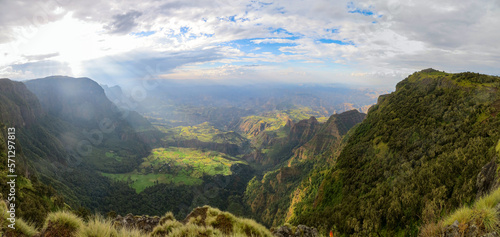 Panoramic view of valley and mountain landscape with clouds and sunrays coming through in the Simien Mountains Ethiopia, Africa