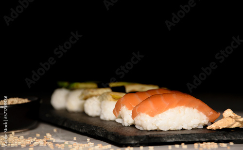 Different types of nigiri's sushi plated in blackboard