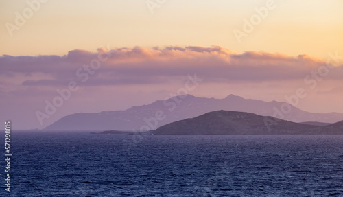 Rocky Island on Mediterranean Sea. Rinia near Mikonos  Greece  Europe. Nature Background. Sunrise Sky