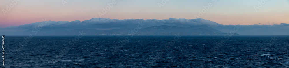 Island on Mediterranean Sea. Tinos, near Mikonos, Greece, Europe. Nature Background Panorama. Sunrise Sky