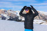 Young man, happy skier, blue sky and mountains, winter in Italy, winter sports lover, mountains in winter, landscape.