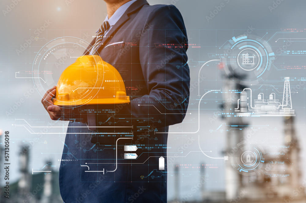 Engineer Inside Engineer and architect supervising work inside a large oil refinery, he ...
