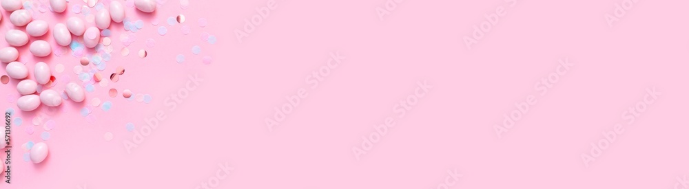 Bunch of candy eggs on pink background. Minimal Easter concept with copy space for text. Festive day backdrop. Flat lay style with minimalistic design. Bunch of candy eggs on pink background. Minimal Easter concept with copy space for text. Festive day backdrop. Flat lay style with minimalistic design.