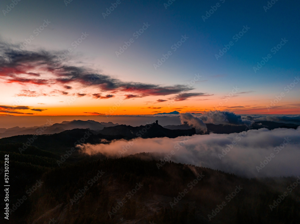 Magical sunset above the clouds with Teide volcano on the horizon. Sunset cinematic view from the top of Gran Canaria Island Pico de las Nieves point.