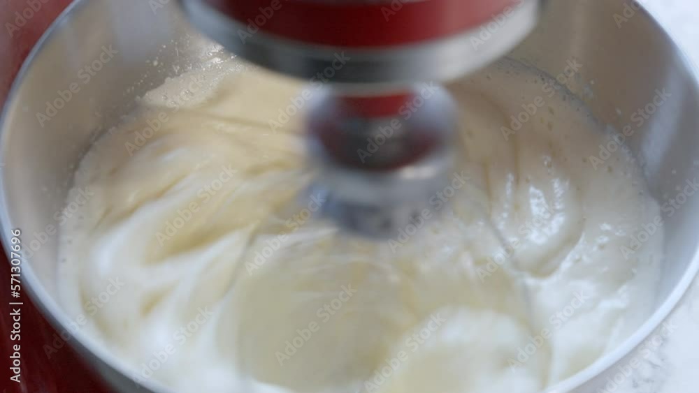 Whipping egg whites with sugar in food processor. Modern silver kitchen stand mixer. Kitchen mixer. Mix the product in a Stand Mixer. Home cooking Selective focus. Whipping egg whites with sugar in food processor. Modern silver kitchen stand mixer. Kitchen mixer. Mix the product in a Stand Mixer. Home cooking Selective focus.