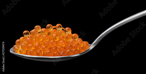Red caviar on spoon for sushi isolated on black background