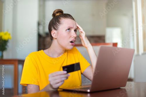 Internet fraud. Nervous sad upset unhappy confused young woman, stressed worried lady having problem with paying, buying online, shopping, stolen money, payments with credit blocked bank card