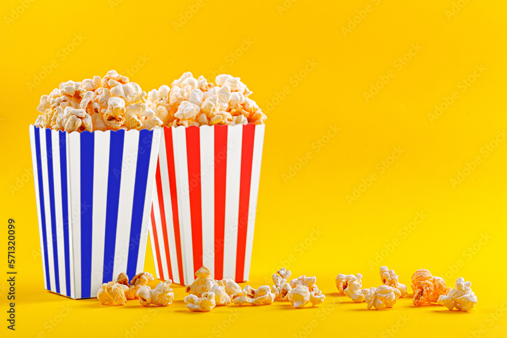 Glass with popcorn on a yellow background