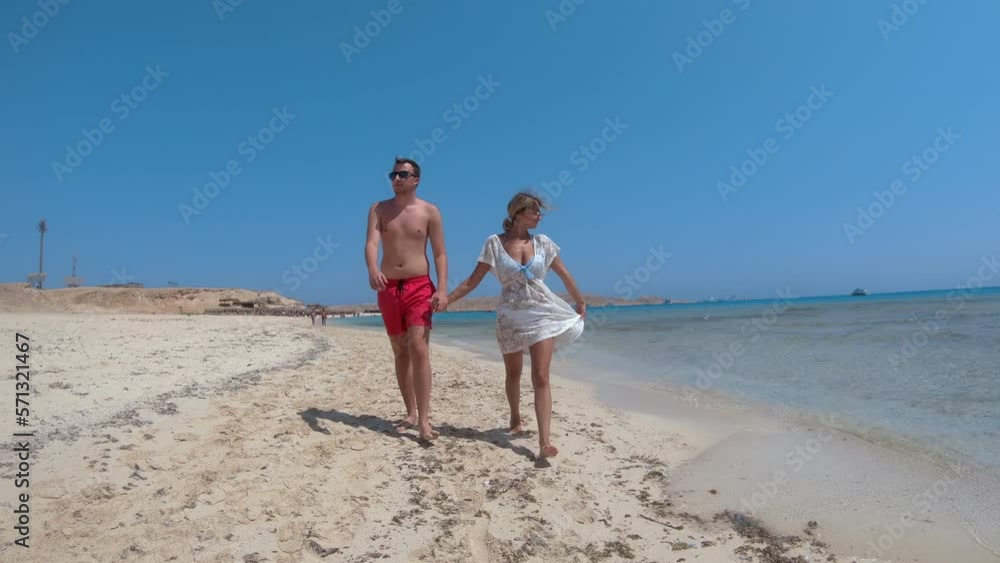 Couple on honeymoon walk on Paradise beach island in Hurghada, Egypt Couple on honeymoon walk on Paradise beach island in Hurghada, Egypt