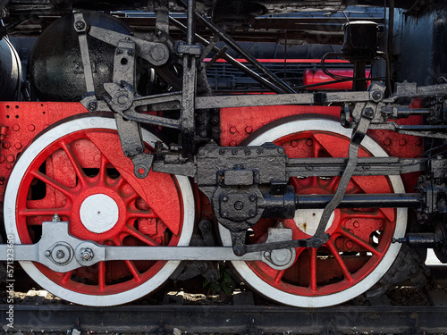 two huge metal wheels of an old steam locomotive