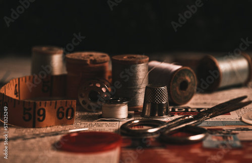 still life shot of thread and antique sewing accessories 
