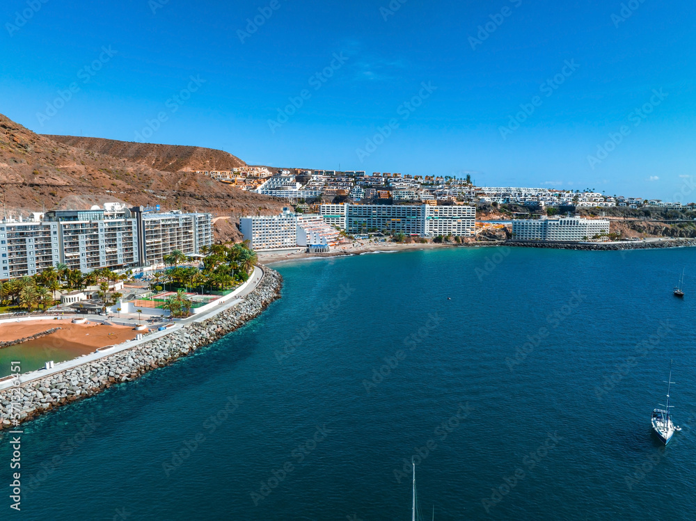 Beautiful aerial landscape with Anfi beach and resort, Gran Canaria, Spain. Luxury hotels, turquoise water, sandy beaches in Spain. Luxury beach vacation concept. Heart shaped island.