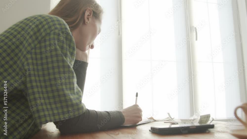 The woman runs her own business. There is money on the table nearby. Repair shop. Live camera effect. The woman runs her own business. There is money on the table nearby. Repair shop. Live camera effect.