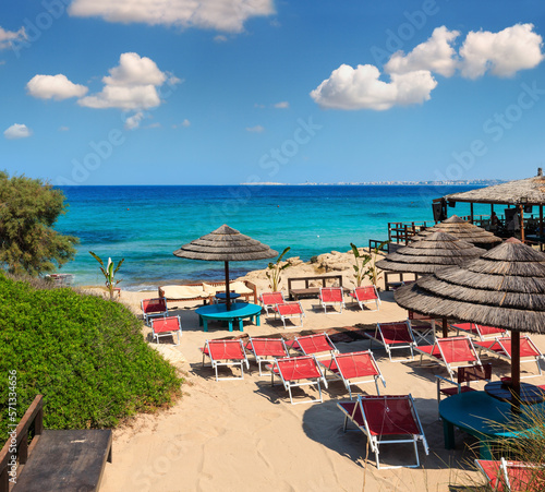 Fototapeta Naklejka Na Ścianę i Meble -  Picturesque Ionian sea beach Punta della Suina,  Salento, Puglia, Italy. Gallipoli town view in far. People unrecognizable.