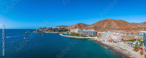 Beautiful aerial landscape with Anfi beach and resort, Gran Canaria, Spain. Luxury hotels, turquoise water, sandy beaches in Spain. Luxury beach vacation concept. Heart shaped island. photo