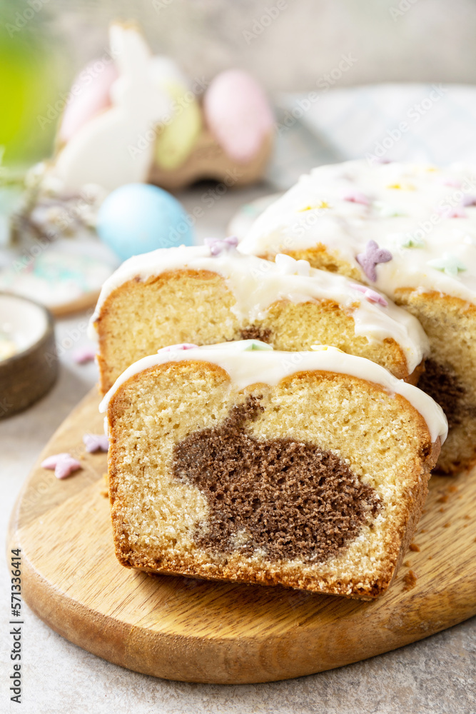 Happy Easter holiday food baking, cupcake with Easter Bunny and colorful eggs on stone background.