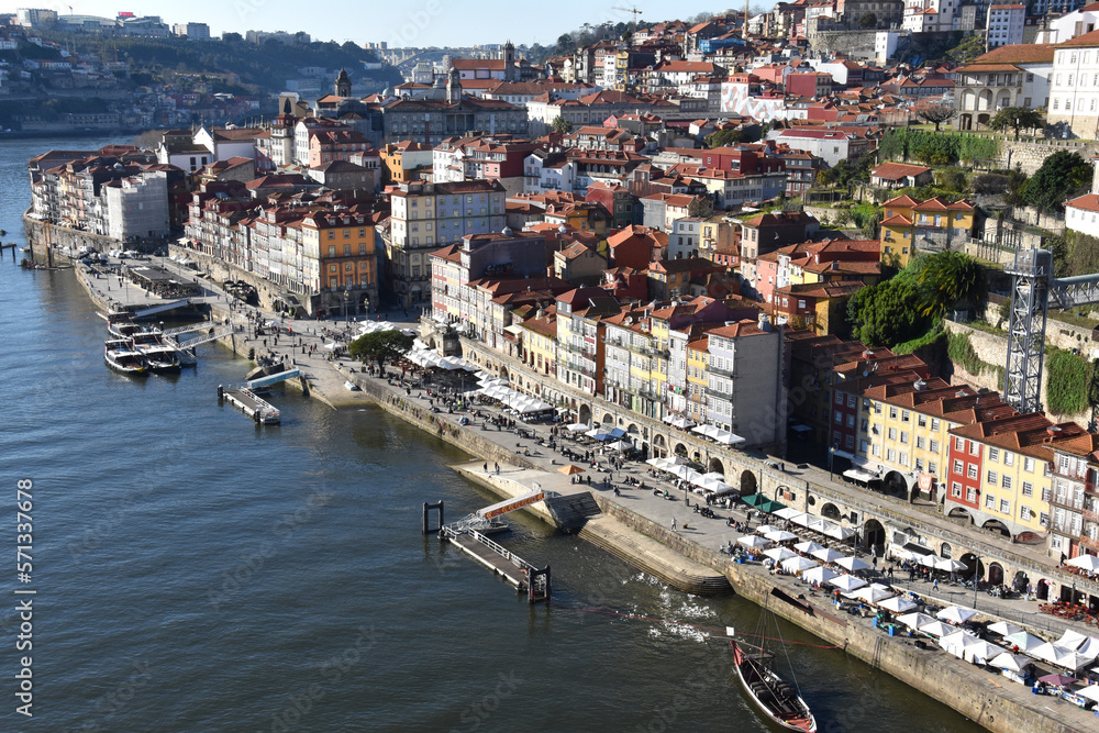 View of bars in Ribeira district in Porto Portugal with Douro river