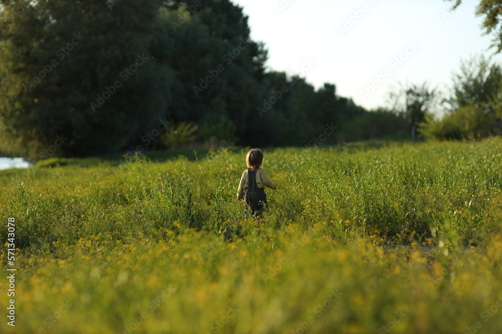 child walking on the grass