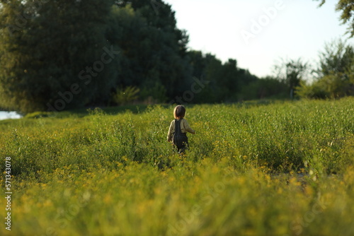 child walking on the grass © Olga