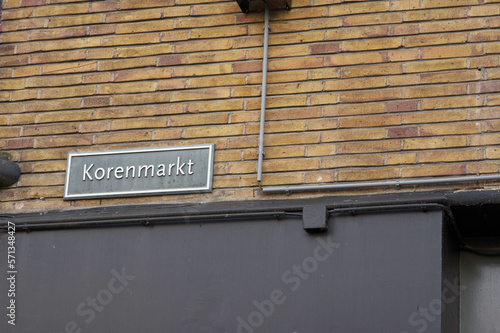 Blue street name sign of Korenmarkt on a brick stone wall  in Arnhem in the Netherlands photo