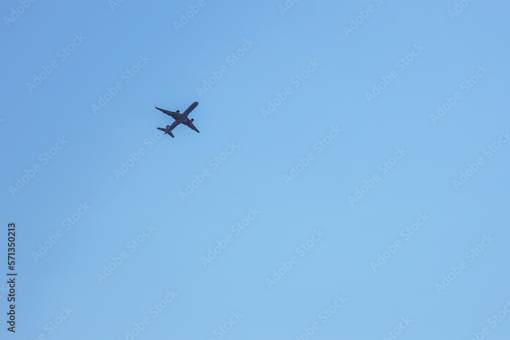Low Angle View Of Silhouette Airplane Against Clear Blue Sky Low Angle View Of Silhouette Airplane Against Clear Blue Sky