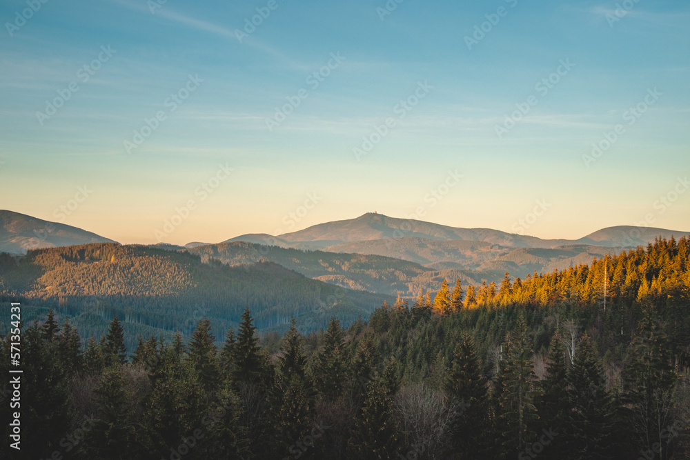View of the spruce forests of the Beskydy Mountains in the east of the Czech Republic with the highest mountain of the region, Lysa Hora, in the distance during sunset