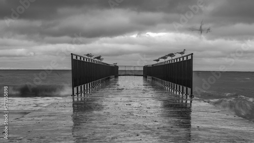 stormy wave crashing on the beach against the stormy sky