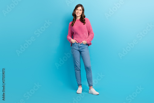 Full length photo of young lovely girl hands pockets wear trendy outfit looking empty space opening shopping mall isolated on blue color background