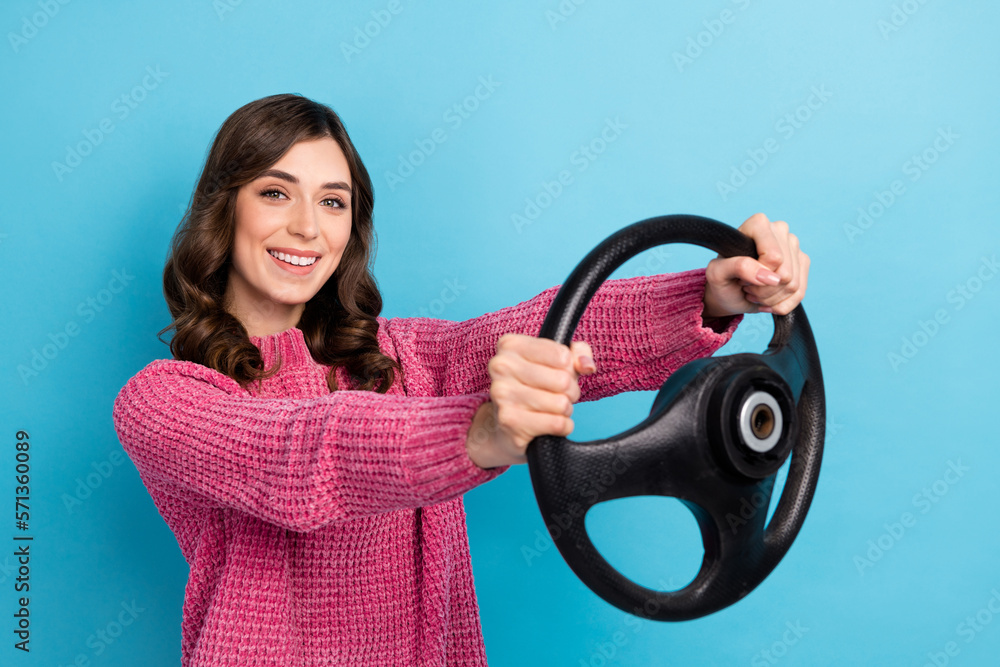 Photo of adorable lovely lady wear stylish clothes driving own new car enjoy weekend trip empty space isolated on blue color background Photo of adorable lovely lady wear stylish clothes driving own new car enjoy weekend trip empty space isolated on blue color background