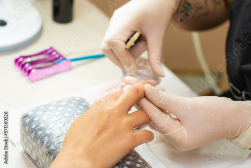 Hands close-up in a beauty salon on a manicure. Background  selective focus