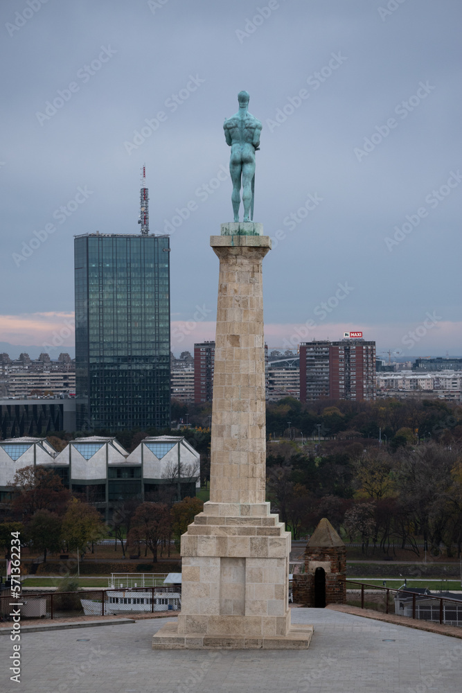 Victor (pobednik) monument close up from behind during overcast day, and New Belgrade in background