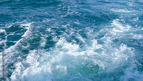 Splash sea wave from cruise ship. Ocean wake and foam