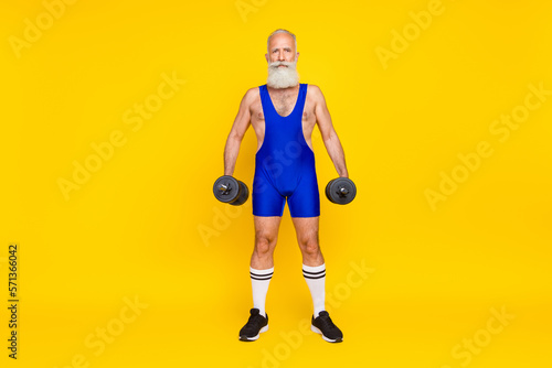 Full length photo of brutal strong senior sporty coach wear retro costume training intense regime isolated on yellow color background